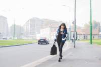 graphicstock-young-handsome-eastern-woman-walking-outdoor-in-the-city-holding-a-smartphone-and-a-bag-overlooking-technology-social-network-business-concept_HauoZat1b